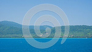 A karimun jawa big island with mountain view from ship with blue sea and sky