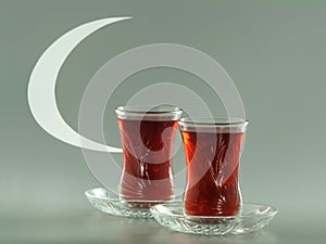 Karkade tea in pear-shaped armudu glasses and white crescent