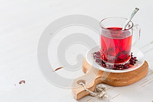 Karkade tea on white wood background