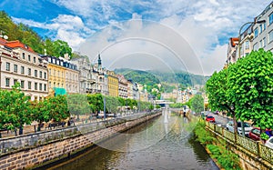 Karlovy Vary historical city centre with Tepla river pedestrian embankment, colorful beautiful buildings