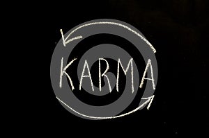 Karma and arrows written on chalkboard