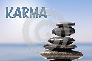 Karma concept. Stack of stones near sea, closeup