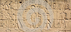 Karnak Temple Complex in Luxor, Egypt. Ancient bas-relief with the hieroglyphs and Egyptian gods