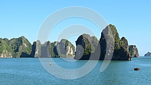 Karst landforms in the sea, the world natural heritage - halong bay in Vietnam at sunset. Natural and travel landscape photo