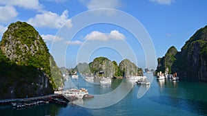 Karst landforms in the sea y Tourist junks in Halong bay in Vietnam, South Asia. The world natural heritage. Travel destination photo