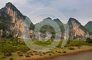 Karst mountains and cliffs behind land tonque along Li River in Guilin, China