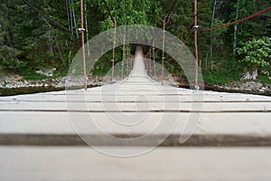 Karst suspension bridge over the river Serga in the forest in cloudy cloudy weather in national Park in Sverdlovsk region cervine