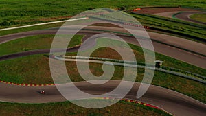 Kart racing or karting training. Kart, go-kart moving on race track. Aerial view of professional auto circuit