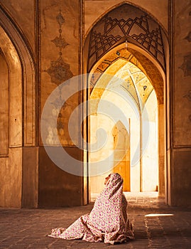 Kashan, Iran - 29th may, 2022: female Tourist wear special robe visit explore beautiful Agha Bozorg Mosque in sunny day