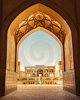 Kashan, Iran - 29th may, 2022: Tourists and pilgrims explore sightseeing beautiful Agha Bozorg Mosque