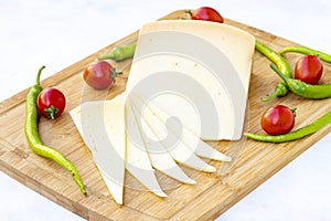 Kashar cheese or kashkaval cheese on wood background photo