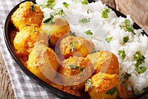Kashmiri dum aloo: spicy potato with rice closeup on the pan. Ho