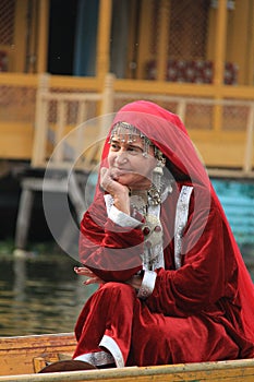 Kashmiri woman in traditional red dress and ornaments