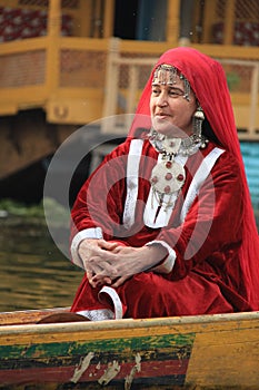 Kashmiri woman in traditional red dress and ornaments