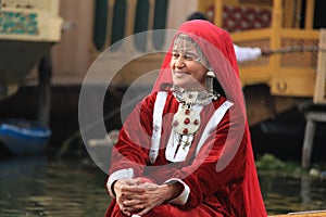 Kashmiri woman in traditional red dress and ornaments