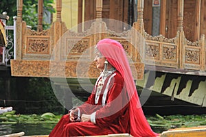 Kashmiri woman in traditional red dress and ornaments