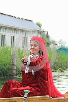 Kashmiri woman in traditional red dress and ornaments