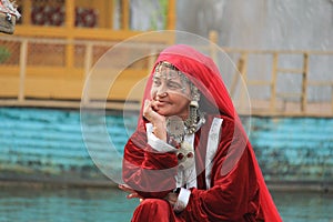 Kashmiri woman in traditional red dress and ornaments