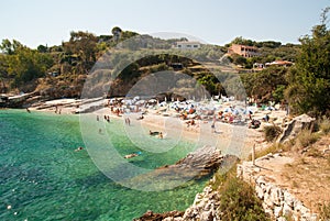 Kassiopi Beach, Corfu Island, Greece. Sunbeds and parasols (sun