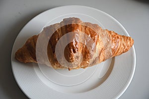 Single croissant on plate in Kastrup Copenhagen Denmark photo