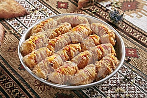Kataifi, Kadaif or Kanafeh with Apple and Caramel on Vintage Traditional Tablecloth photo