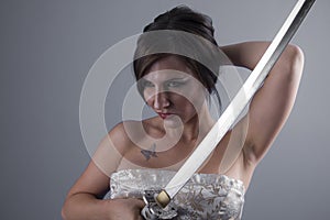 katana, beautiful brunette girl with a Japanese sword in aggressive attitude