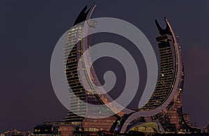 Katara Hospitality Tower, Crescent Tower, in Lusail, Qatar at dusk photo