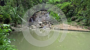 Kathu waterfall water gently flowing down the rocks Patong Phuket Thailand