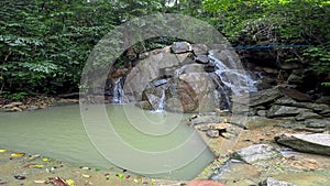 Kathu waterfall water gently flowing down the rocks Patong Phuket Thailand