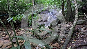 Kathu waterfall water gently flowing down the rocks Patong Phuket Thailand