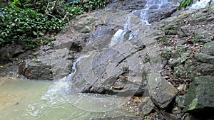 Kathu waterfall water gently flowing down the rocks Patong Phuket Thailand