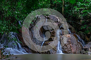 Kathu waterfall water gently flowing down the rocks Patong Phuket Thailand Asia