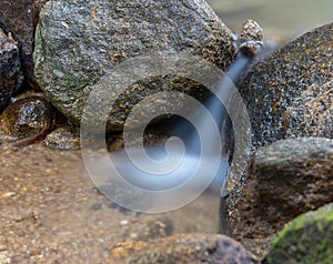 Kathu waterfall water gently flowing down the rocks Patong Phuket Thailand Asia