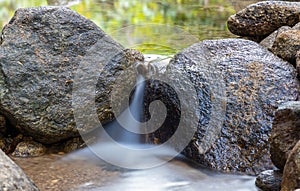 Kathu waterfall water gently flowing down the rocks Patong Phuket Thailand Asia