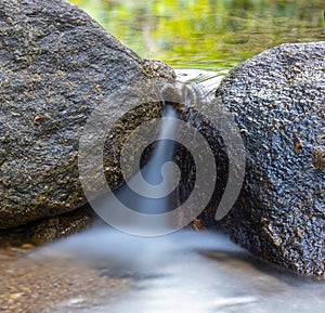 Kathu waterfall water gently flowing down the rocks Patong Phuket Thailand Asia