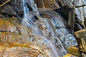 Kathu waterfall water gently flowing down the rocks Patong Phuket Thailand Asia