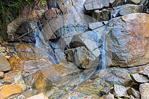 Kathu waterfall water gently flowing down the rocks Patong Phuket Thailand Asia