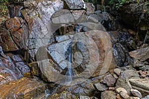 Kathu waterfall water gently flowing down the rocks Patong Phuket Thailand Asia