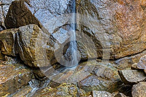 Kathu waterfall water gently flowing down the rocks Patong Phuket Thailand Asia