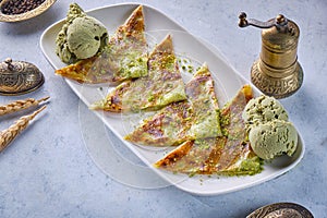 Katmer Turkish dessert with pistachio and ice cream