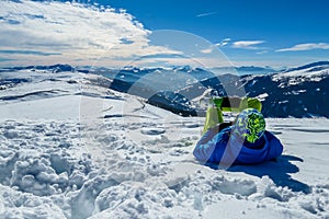 Katschberg - A man lying on the powder snow with his skies aned enjoying the winter day in Austrian Alps