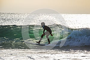 Two teenage boys are surfing before school in Japan