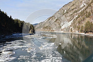 Katun river covered with ice in autumn, village  Barangol, Altai Republic, Russia