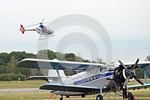 Guimbal Cabri G2 two-seat light helicopter above Antonov An-2 transport aircraft