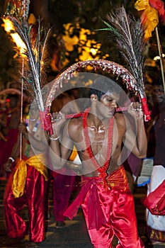 A Kavadi Dancer performs through the streets of Kandy during the Esala Perahera in Sri Lanka.