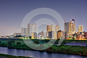 Kawasaki, Japan skyline on the Tamagawa River photo