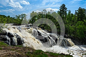 Kawishiwi Falls in Ely Minnesota USA With Cloudy Blue Sky