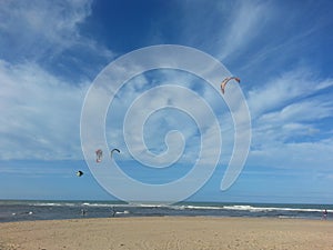 Kay surfers, blue sky and clouds