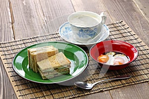 Kaya jam toast sandwich with a cup of white coffee