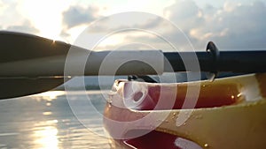 Kayak on the beach forward view from sea kayak on calm water at beautiful summer sunset with lens flare effects, no